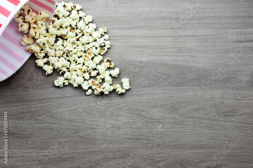 Popcorn, fallen and scattered from plastic bucket