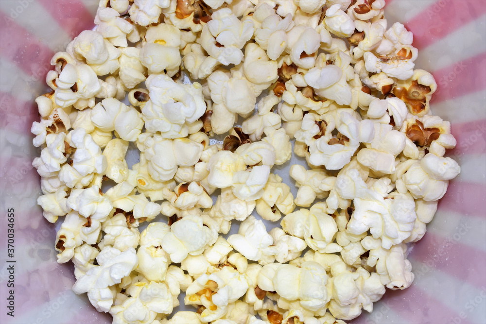 Scattered popcorn, close up inside a plastic bucket. Scattered popcorn, close up inside a plastic bucket.