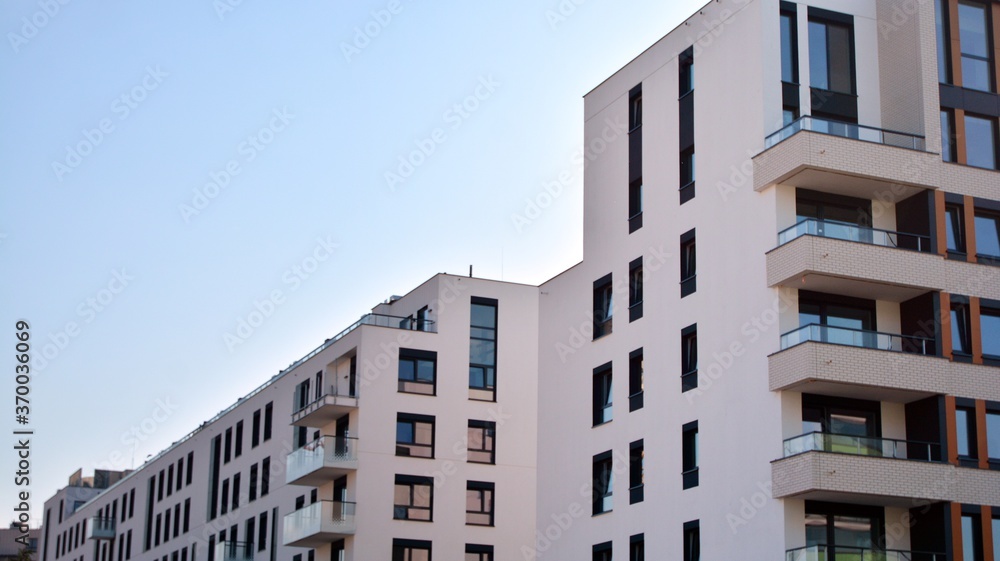 Fototapeta premium Modern and new apartment building. Multistoried modern, new and stylish living block of flats.