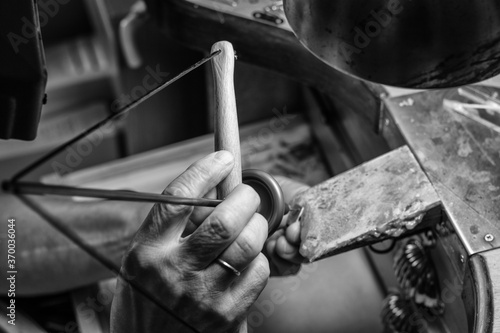 Hands of a craftsman jeweler working on jewelry. Goldsmith. Goldsmith workshop jewels and articles of work value