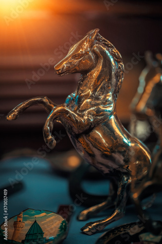Antique bronze horse figure on the counter in sunday flea market. Vintage decoration elements for sale at the bazaar. 