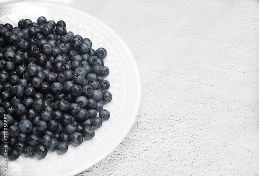 Blueberries are on a white plate. The view from the top. Place for copy space Blueberries are on a white plate. The view from the top. Place for copy space