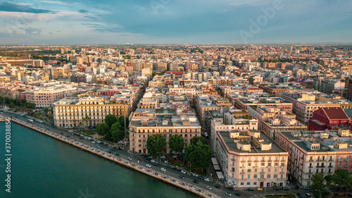 Beautiful panoramic aerial view photo from flying drone at sunset to Bari Apulia City port boats and yachts Sea Coastline, Teatro Margherita, and Bari city skyline. Bari ,Apulia, Italy (Series) photo