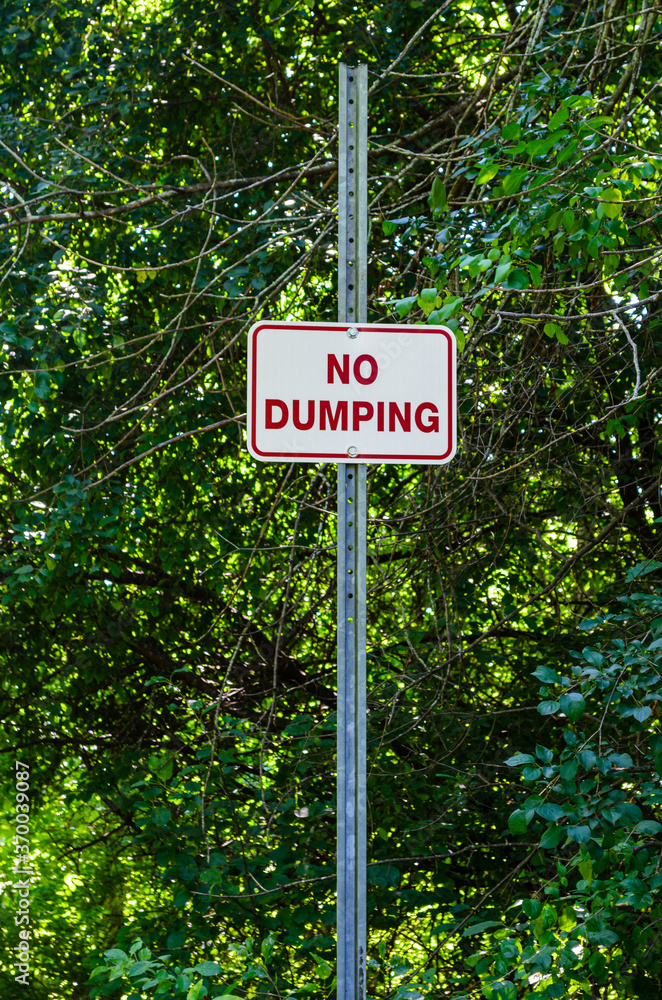 No Dumping sign next to a forested area