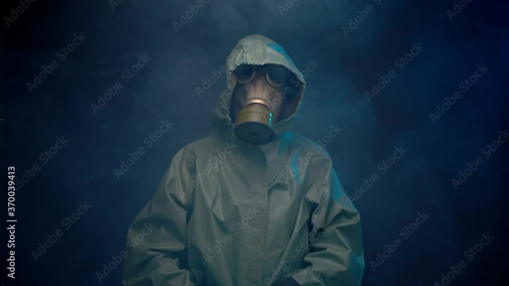Man in gas mask and protective suit in the smoke Man in gas mask and protective suit in the smoke