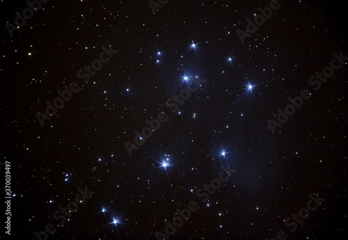 The iconic Pleiades star cluster high in the night sky