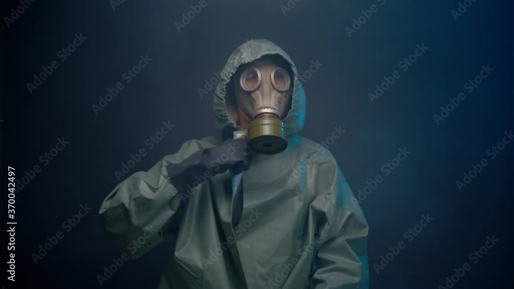 Man in gas mask and protective suit in the smoke Man in gas mask and protective suit in the smoke