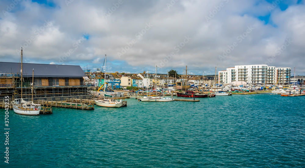A view towards boats moored on the north bank of the River Adur at Shoreham, Sussex, UK