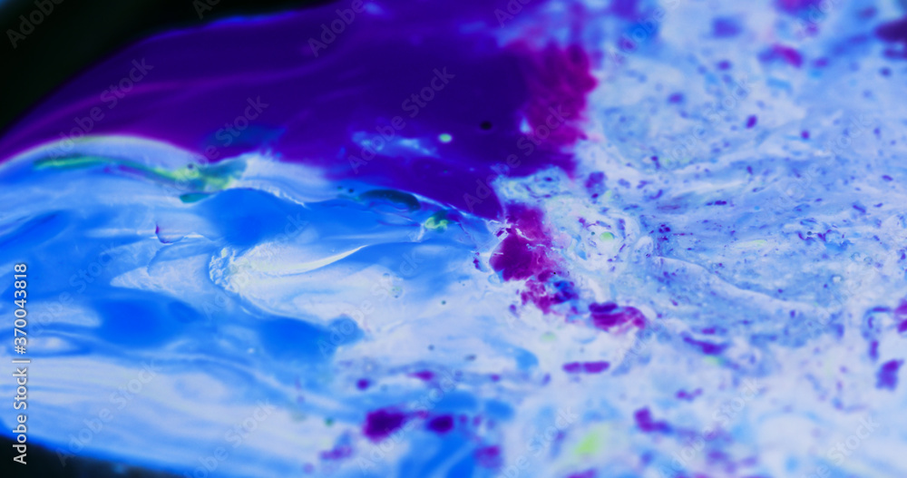 Macro paint creative unique image. Oil mixed dye, paint, macro images, in motion. Print, digital artwork, wallpaper, backgrounds, banners, cards, websites. Neon blue, purple, movement, vibrant