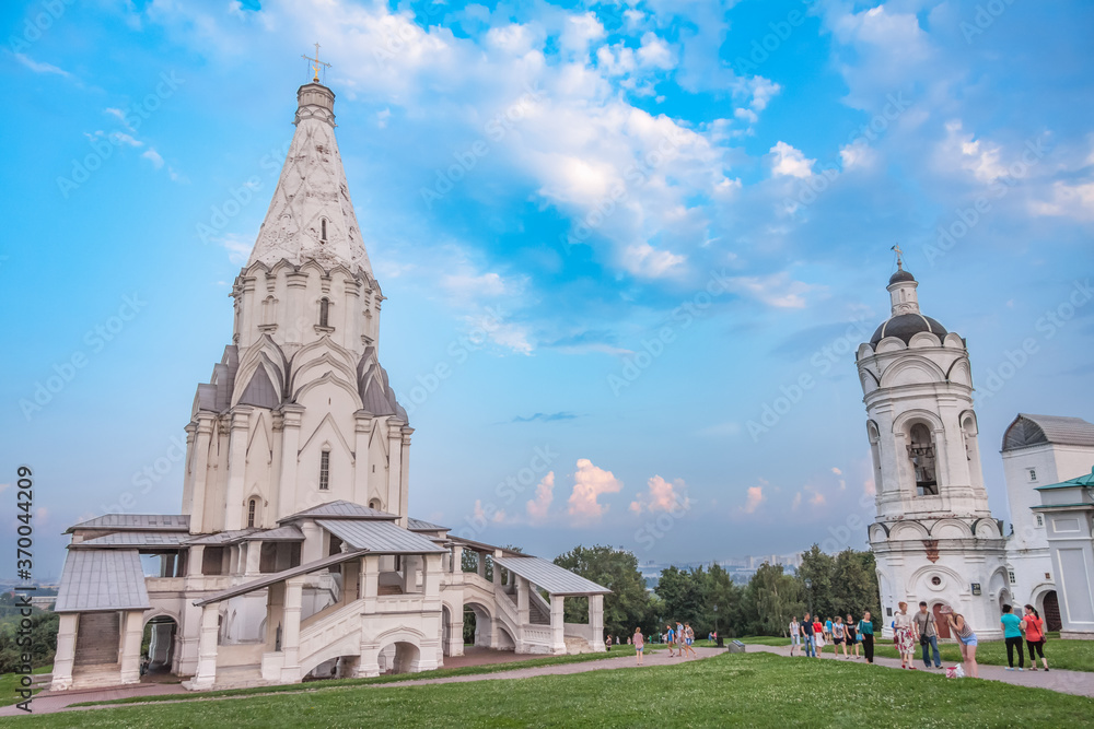 Church of the ascension and the bell tower in Kolomenskoye on the background of the fantastic sky, summer day