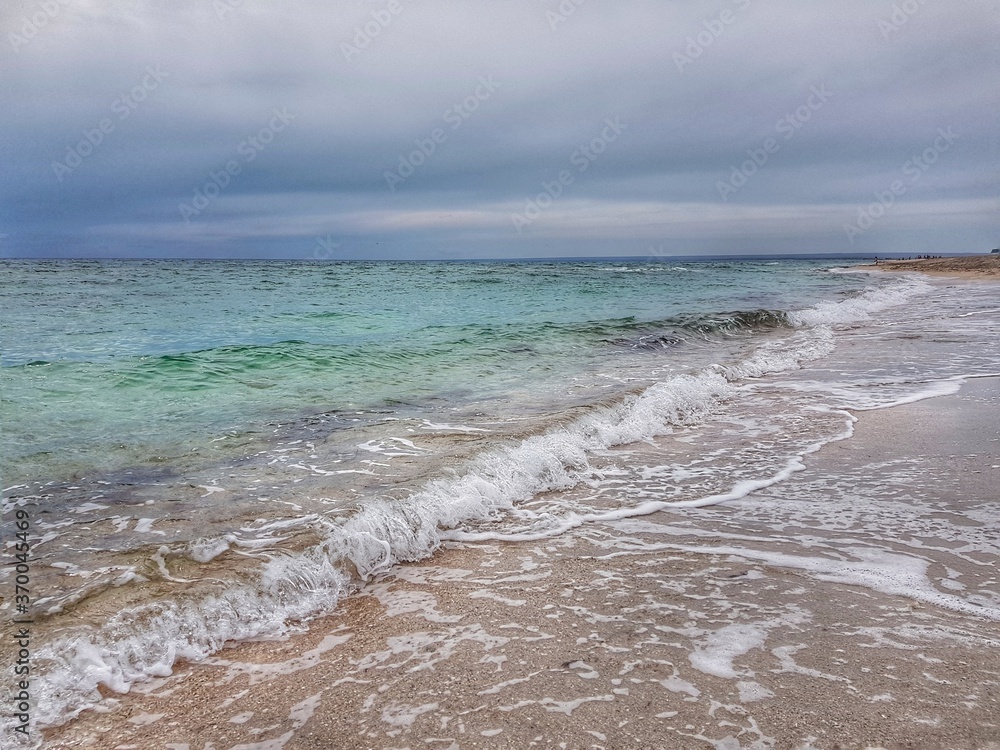 Crimea. Belyaus Beach. Transparent sea before the rain. Small wave.