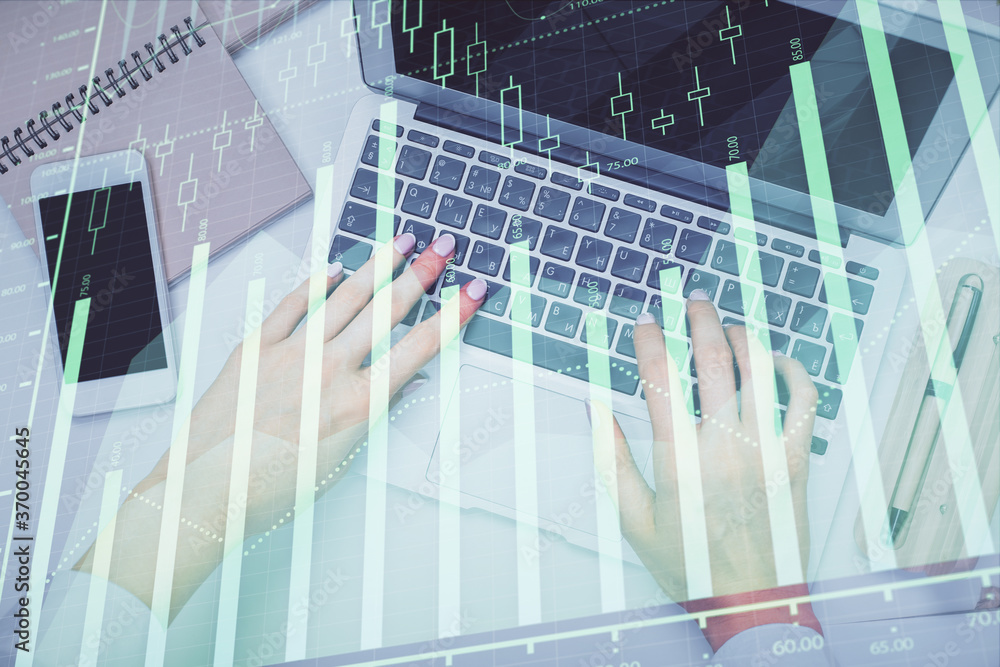Double exposure of woman hands working on computer and forex graph hologram drawing. Top View. Financial analysis concept. Double exposure of woman hands working on computer and forex graph hologram drawing. Top View. Financial analysis concept.