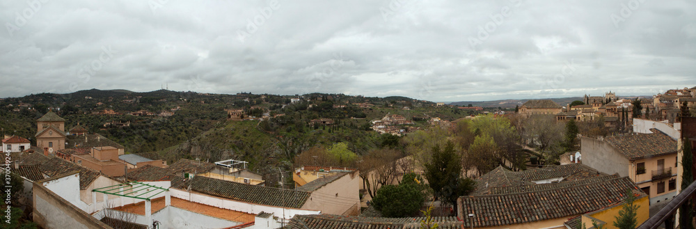 Architecture. Cityscape. Panorama view of the city and buildings under a cloudy sky in Toledo, Spain.