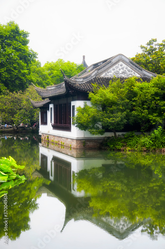 Photography a traditional chinese building on a pond in guyi gardens shanghai china