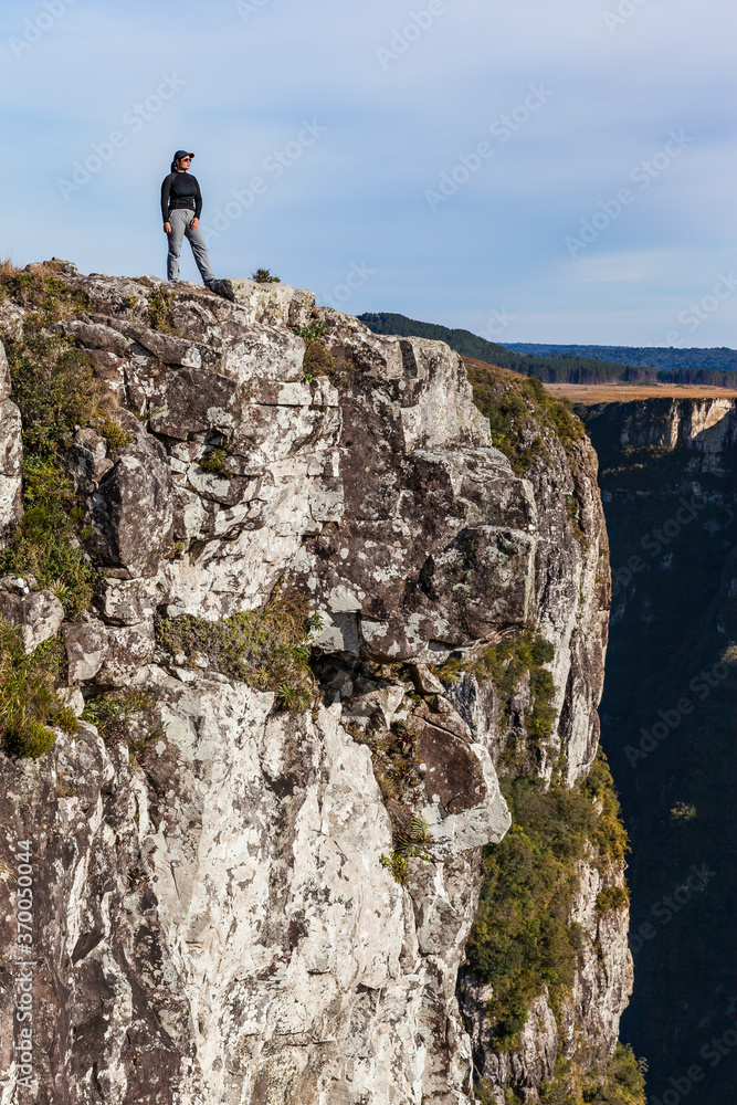 Girl at the border of a huge canion in Brazil