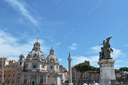 Rome panorama: domes and statues with partly cloudy sky.
