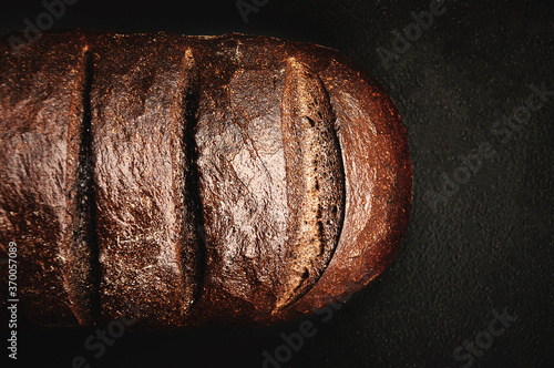 Photography Artisan Loaf of Pumpernickel Bread on Dark Background