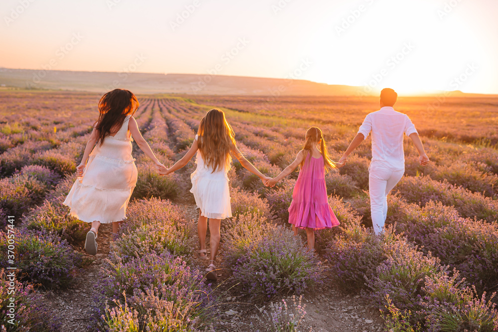 Family of four in lavender flowers field Family of four in lavender flowers field