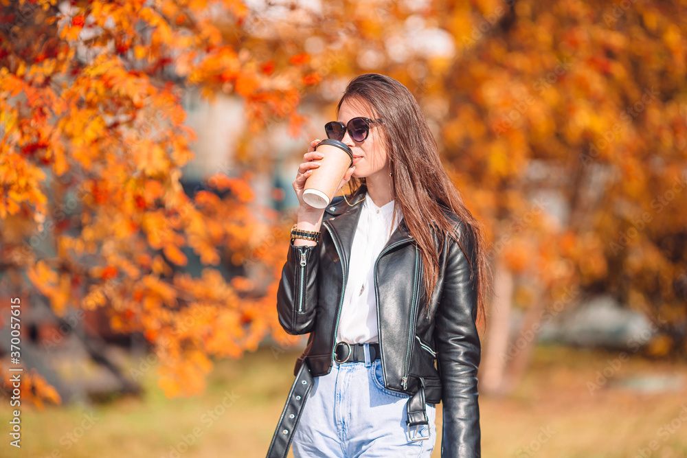 Fall concept - beautiful woman in autumn park under fall foliage Fall concept - beautiful woman in autumn park under fall foliage