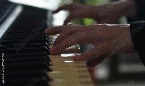 Fingers playing piano on the keys