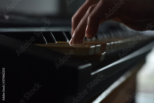 Fingers playing piano on the keys