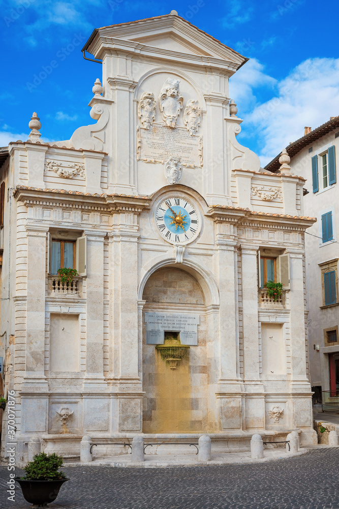 Fototapeta premium The 18th century baroque Fontana di Piazza Mercato (Market Square Fountain), with ancient clock, in the historic center of Spoleto