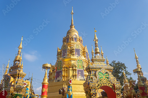 Phayao, Thailand - Dec 31, 2019: Gold Pagoda or Stupa on Blue Sky Background in Wat Phra Nang Din or Phra Nang Din Temple at Chiang Kham District Phayao Thailand