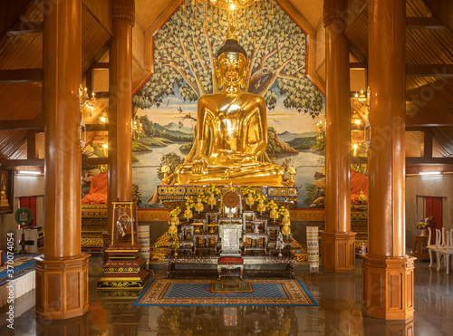 Phayao, Thailand - Dec 31, 2019: Gold Buddha Statue with Warm Light in Wat Yuan or Yuan Temple in Chiang Kham District Phayao Thailand in Front View