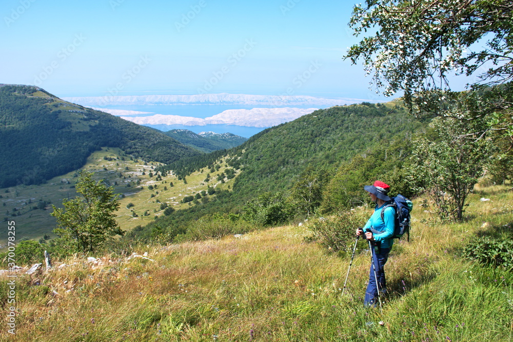 Fototapeta premium Senior woman hiking in Velebit mountain, Croatia