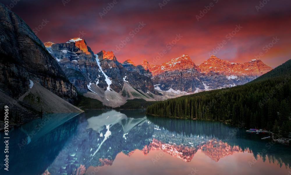 Dramatic sunrise during first break of dawn at Moraine Lake in the Canadian Rockies of Banff National Park.