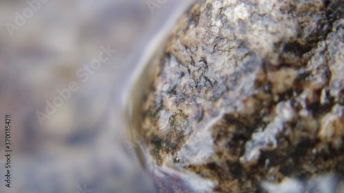 Macro of rock in moving river water - XCU, Still, Tripod photo