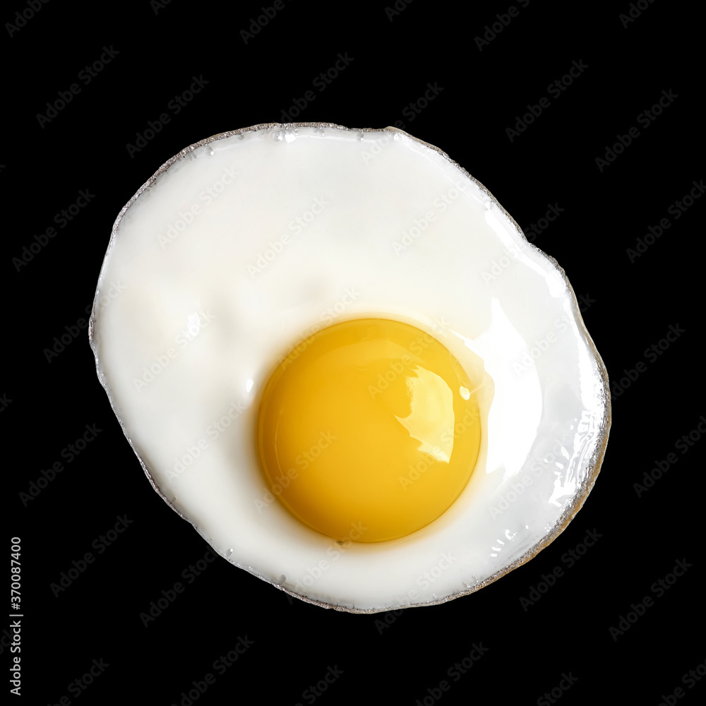 Closeup photo of fried egg isolated on black background Closeup photo of fried egg isolated on black background