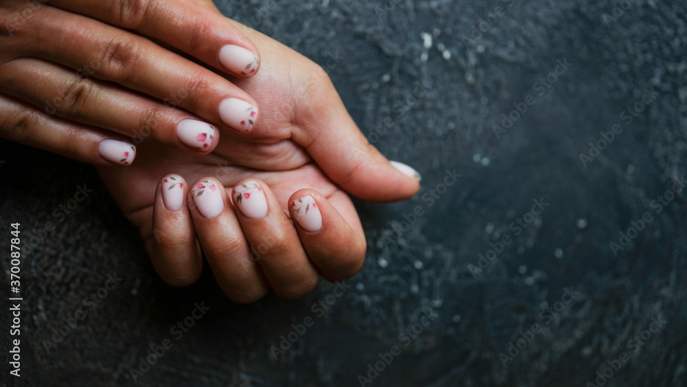 Women's hands with colorful patterns on the nails. Summer colors trend. Top view. The place for text. Women's hands with colorful patterns on the nails. Summer colors trend. Top view. The place for text.