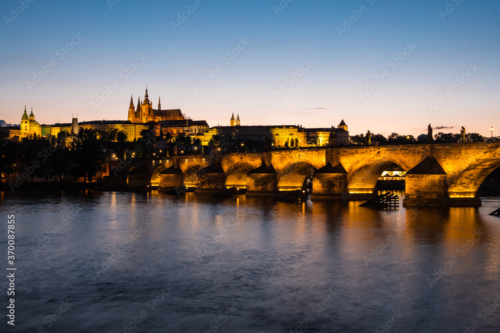 Charles Bridge Illuminated in Prague at Dusk across River Vltava with Saint Vitus Cathedral and Prague Castle