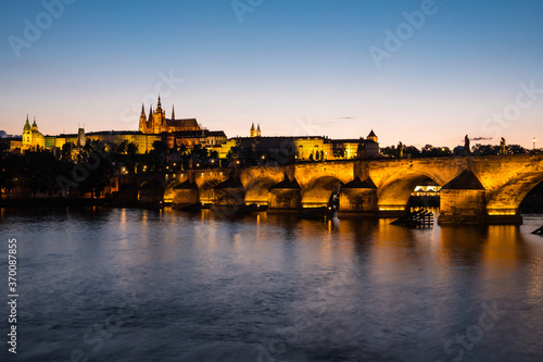 Charles Bridge Illuminated in Prague at Dusk across River Vltava with Saint Vitus Cathedral and Prague Castle
