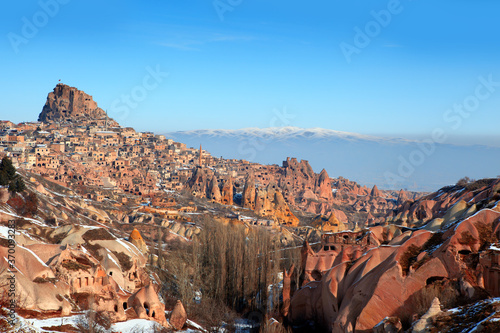 Cave town and rock formations city in Goreme national park with snow-covered around - Cappadocia, Turkey