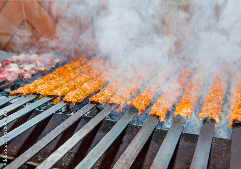 Cooking Adana kebab on BBQ grill Cooking Adana kebab on BBQ grill