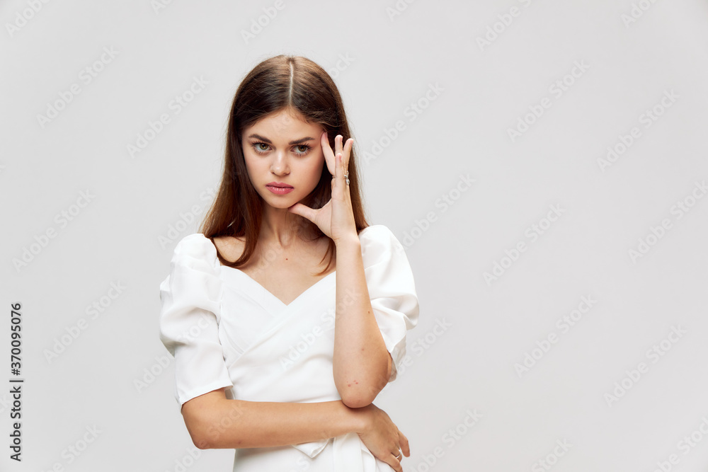 Emotional woman holding hand near face white dress cropped view Emotional woman holding hand near face white dress cropped view