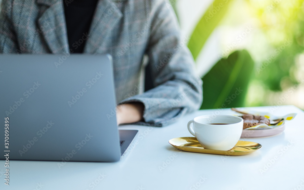 Closeup image of a business woman using and working on laptop computer in office Closeup image of a business woman using and working on laptop computer in office