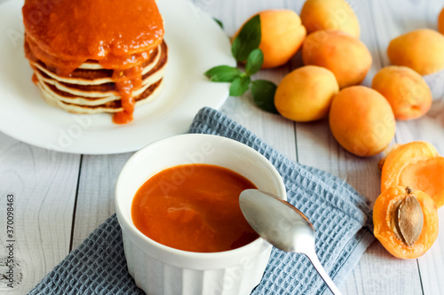 Homemade apricot jam. Pancakes with apricot jam. Honey, food.