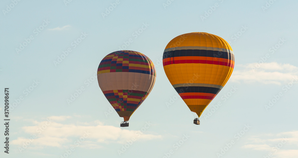 Obraz premium Hot air balloons profiled on clear blue sky, in Cappadocia, Turkey