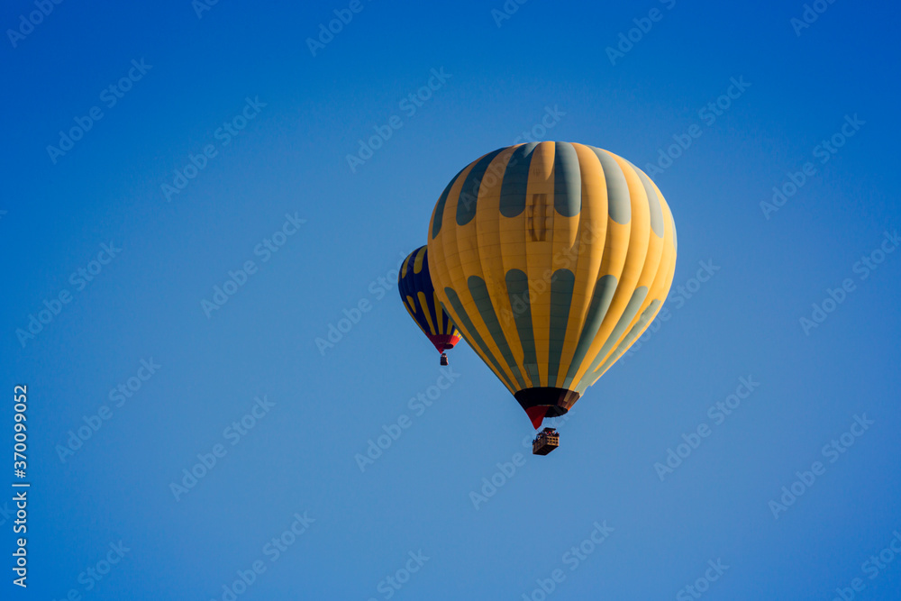 Hot air balloons profiled on clear blue sky, in Cappadocia, Turkey Hot air balloons profiled on clear blue sky, in Cappadocia, Turkey