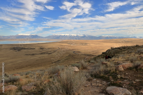 Rocky landscape at Antelope Island surrounded by snowcapped mountains, Utah