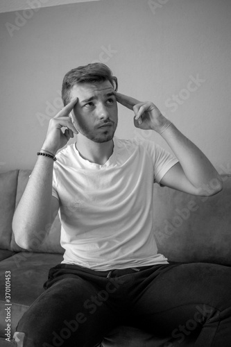 Black and White, Caucasian man isolated on green background having doubts and thinking © Hamza