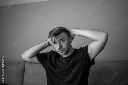 Black and White, Emotional actor young man in a t-shirt posing on a green background