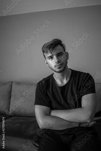 Black and White, Young european man posing in a isolated green room