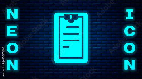 Glowing neon Clipboard with checklist icon isolated on brick wall background. Control list symbol. Survey poll or questionnaire feedback form. Vector.