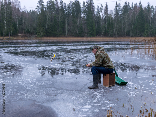 winter angler fishing on ice