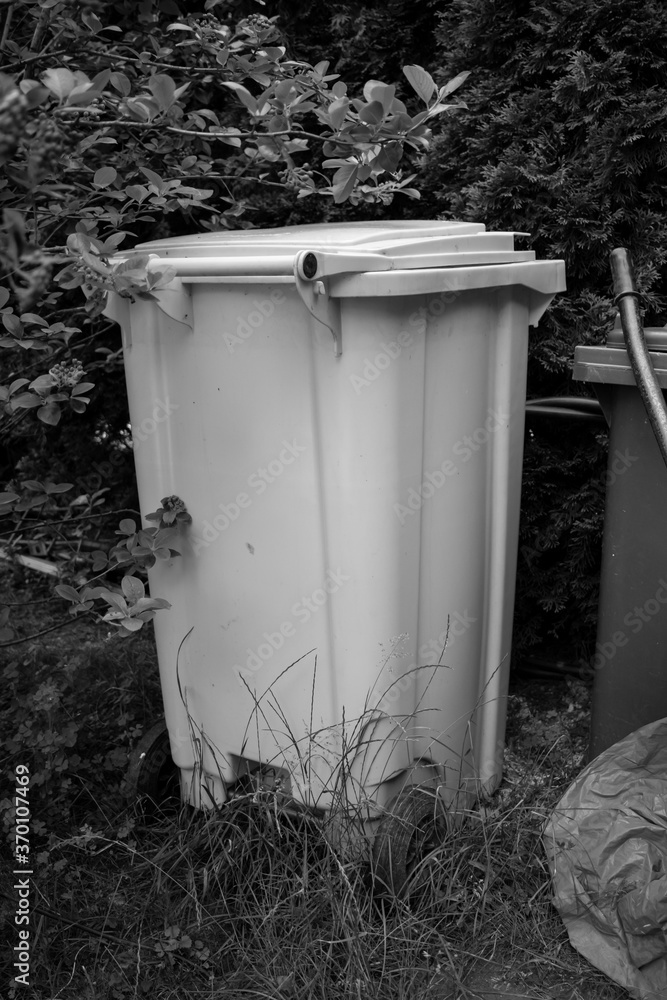 Yellow garbage container in a park AM Yellow garbage container in a park AM