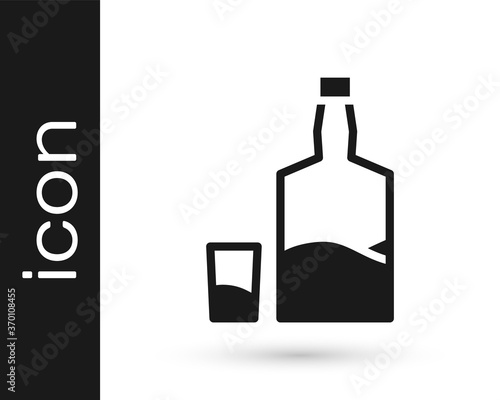 Black Tequila bottle and shot glass icon isolated on white background. Mexican alcohol drink. Vector.